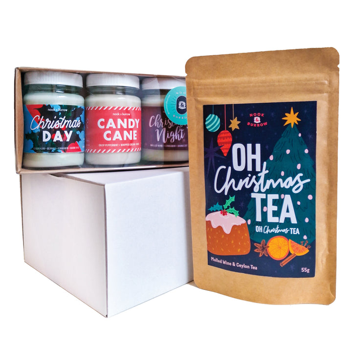 three mini candles—“Christmas Day,” “Christmas Night,” “Candy Cane,” and “Oh, Christmas Tea”—with a gift box