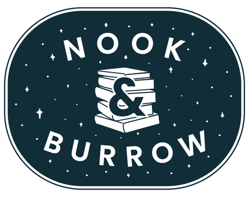 Nook & Burrow badge in dark navy with white text and a stack of books with an ampersand overlayed on top of the book stack. there are white stars surrounding the text and book stack