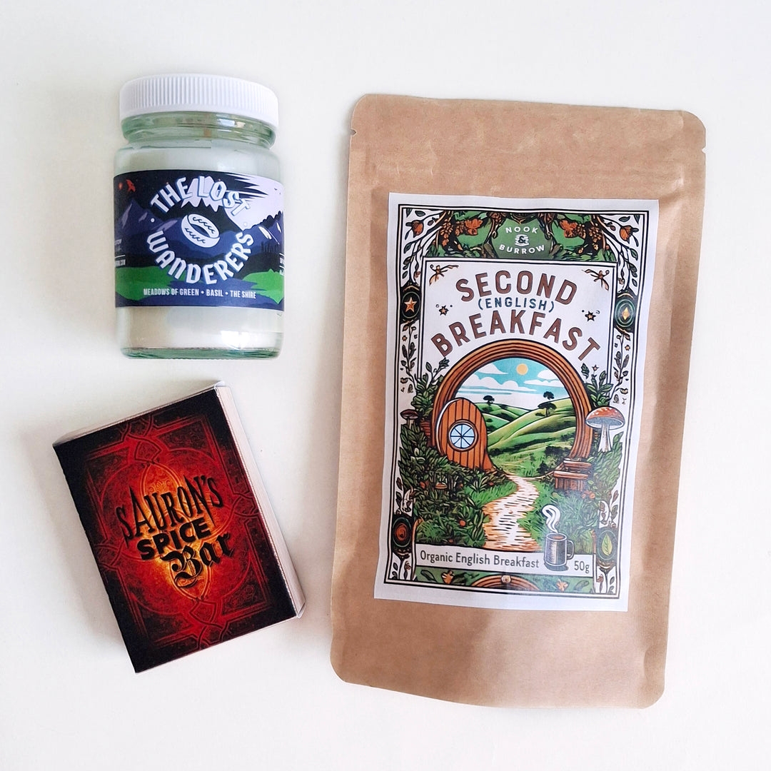 Hobbit-inspired trio featuring “Second Breakfast” English Breakfast tea, “The Lost Wanderers” candle, and “Sauron’s Spice Bar” soap.